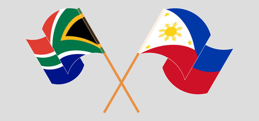 Crossed and waving flags of South Africa and the Philippines