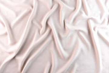 Abstract silk background pale pink fabric fancy liquid waves. Bright color abstract fabric texture background. Soft elegant wave fabric. Elegant folds of satin, silk and fine cotton, flat lay