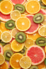 top down background view made of Fresh Sliced organic kiwi, oranges and lemons close-up