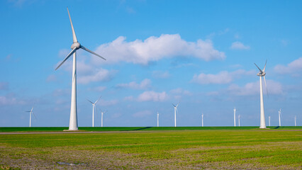 Fototapeta premium windmill park with clouds, windmill park in the ocean aerial view with wind turbine Flevoland Netherlands Ijsselmeer. Green energy 