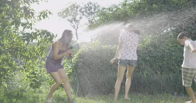 kid, mother, hose, water, child, outdoor, family, summer, garden, fun, people, girl, splash, happy, spray, joy, grass, childhood, parent, sprinkler, playing, happiness, green, mom, woman, leisure, dro