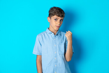 Beautiful kid boy wearing  casual clothes  cutting throat with hand as knife, threaten aggression...