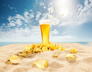 Glasses of foamy, chill, lager beer with chips appetizers on sand against ocean and blue sky background. Concept of beer, brewery, holidays and vacation, traditions, festival, alcohol drink, ad