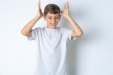 Beautiful kid boy wearing grey casual t-shirt  goes crazy as head goes around feels stressed...