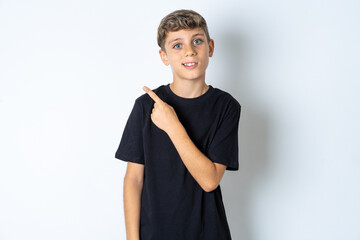 Beautiful kid boy wearing black casual t-shirt glad cheery demonstrating copy space look novelty