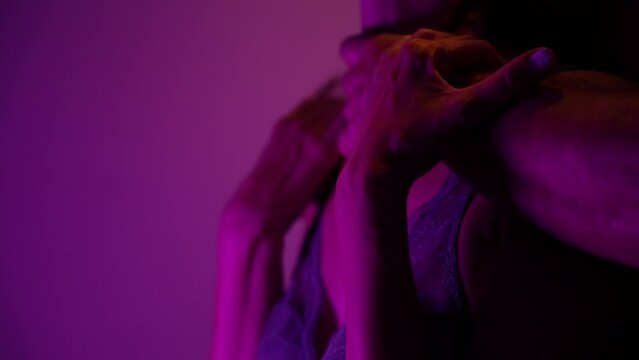 Male romantically touching female skin