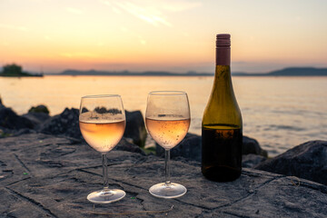 drinking wine on a date next to lake Balaton at sunset in Balatonlelle
