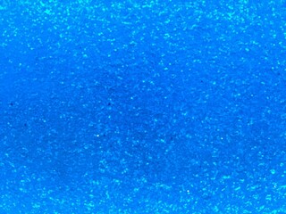 Blue light reflective glitter image use as texture or background.