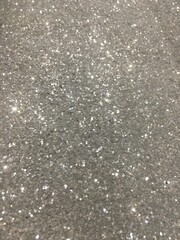 Silver light glitter image use as texture or background.