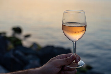 drinking wine next to lake Balaton at sunset in Balatonlelle