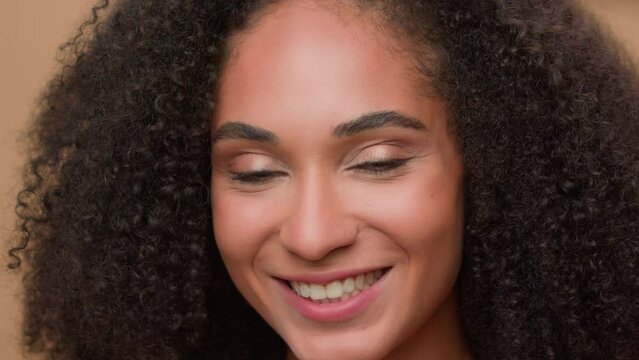 Close up female perfect face clean smooth skin make-up smiling happy African American woman model girl beautiful lady smile at camera posing in studio beauty skincare fashion headshot look to side
