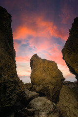 lanscape views of indrayanti beach yogyakarta gunungkidul indonesia  cliffs and rocks on the seafront with beautiful clouds at sunrise or sunset
