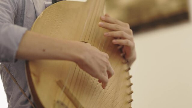 A person with beautiful fingers plays the stoessel lute
