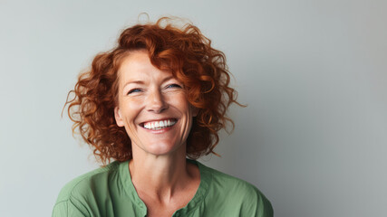 Delighted Irish woman in 40s, red curls, green shirt