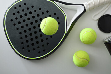 Black and white paddle tennis racket and ball pot top