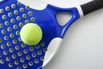 Detail of blue paddle tennis racket and ball top view