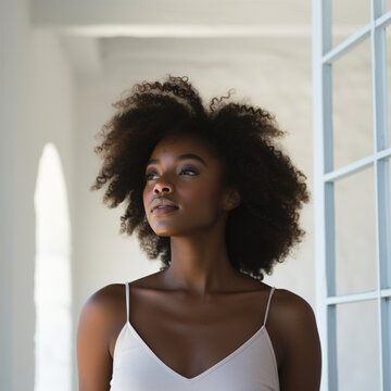 African-American woman with curly hair doing a photoshoot wearing casual clothes