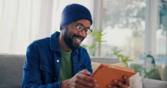 Black man, coffee and tablet in home on sofa in living room, social media or internet. Technology, drink tea and happy African person in lounge on website for streaming video, film or movie to relax