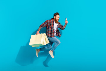 Full body photo of run funky virtual shopaholic order more clothes bargains young man selfie cadre phone isolated on blue color background