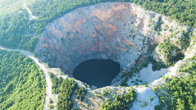 Aerial overview around the Red lake (Crveno jezero) in sunny Imotski, Croatia