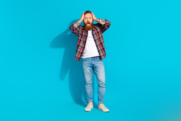 Fototapeta premium Full size body photo cadre of scared confused mature man hands head staring how many problems he got isolated on blue color background