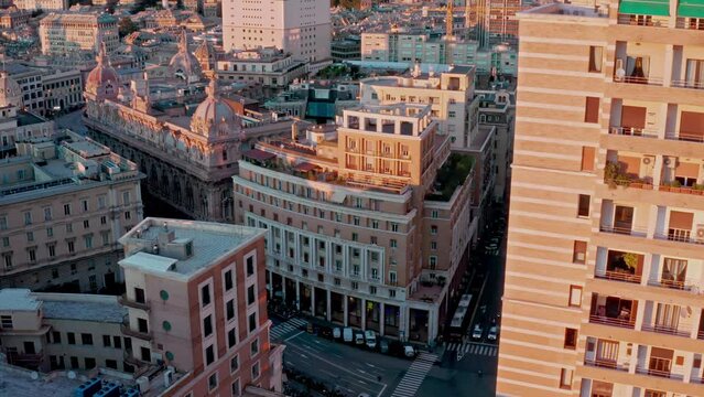 Aerial view at sunset over historic Piazza Dante with street activity, Genoa