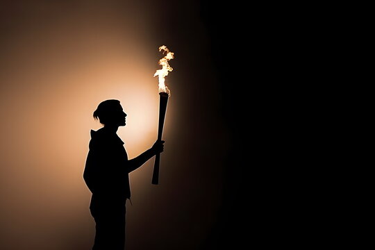 Silhouette of torchbearer athlete standing with Olympic torch at sunset with copyspace on black background