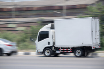 Fototapeta na wymiar Truck running on the road, Small truck on the road, motion image of small truck running on the load.