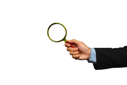 Businessman holding a magnifying glass while standing against a transparent background.