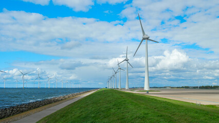 windmill park in the ocean aerial view with wind turbine Flevoland Netherlands Ijsselmeer. Green energy 