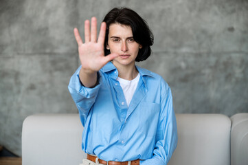 Woman doing stop sign with palm of hand expressing rejection