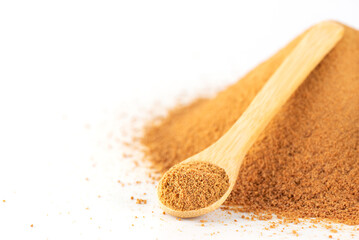 Brown unrefined cane sugar Panela on a white bacground, closeup, selective focus.
