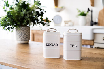 sugar and tea canisters set in retro style on wooden dining table