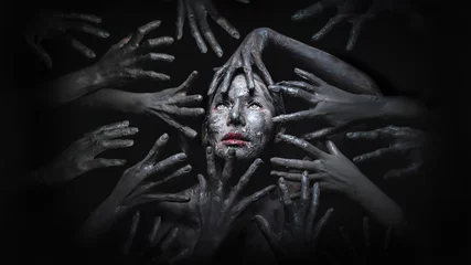 Fotobehang Halloween concept of fancy makeup of scary witch face surrounded by devil hands in the dark background © Mongkolchon