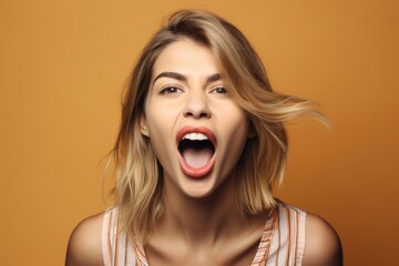 studio shot of an attractive young woman showing her tongue