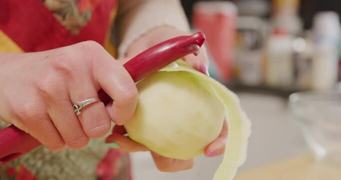 Peeling green apple with apple peeler granny smith