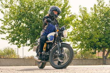 Motorcyclist riding motorbike during lesson on motordrome