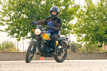 Fototapeta na wymiar Focused motorcyclist riding motorbike on motordrome