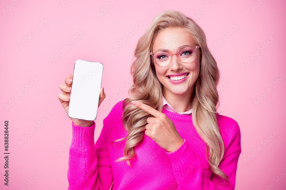 Wall mural Photo of lovely adorable girl wavy hairdo stylish outfit glasses hand hold empty space novelty offer isolated on pink color background