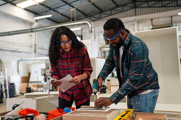 Couple of carpenters working together design crafting with wood in a workshop building furniture for interior design, Small family business concept of young entrepreneurs