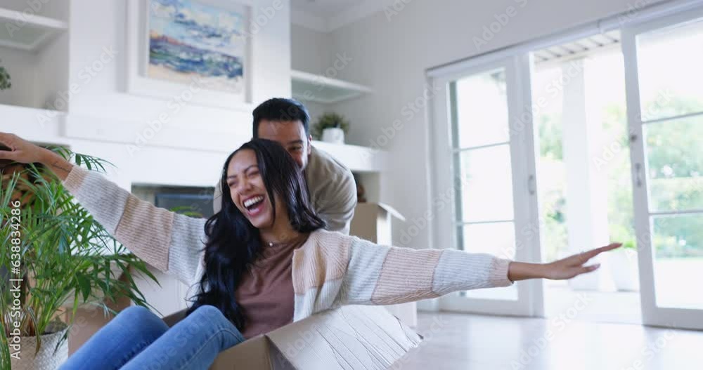 Poster Couple, moving and fun at home with cardboard box race and freedom at new property. Happy, smile and woman and man together playing in house with celebration, dream household and games on floor