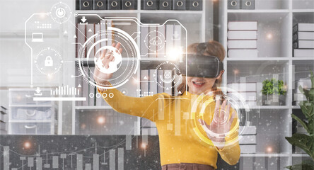 Businesswoman in comfortable clothes using Virtual Reality simulator headset and developing a new project. Concept of virtual reality and successful business