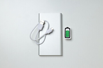 Powerbank and cord on white background, top view