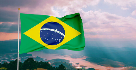 Brazil national flag cloth fabric waving on beautiful grey sky Background.