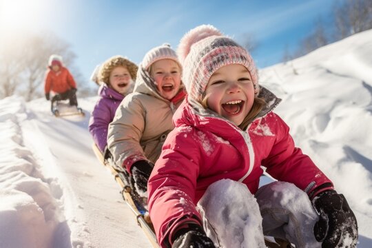 Happe Children sledding down a snowy hill. Winter vacation concept
