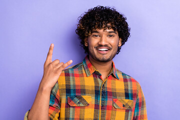 Photo of positive nice man toothy smile hand fingers demonstrate heavy metal symbol isolated on violet color background
