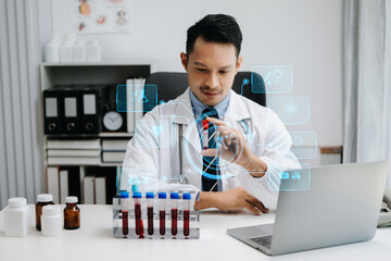medical technology concept,smart Asian doctor hand working with modern laptop computer with his...