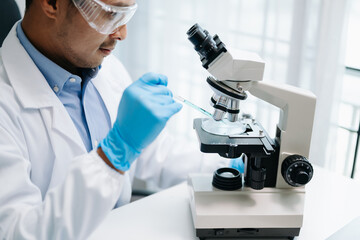 Scientist mixing chemical liquids in the chemistry lab. Researcher working in chemical laboratory.