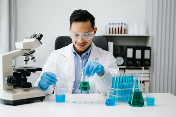 Modern medical research laboratory. male scientist working with micro pipettes analyzing...