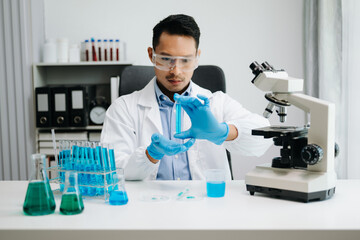 Modern medical research laboratory. male scientist working with micro pipettes analyzing...